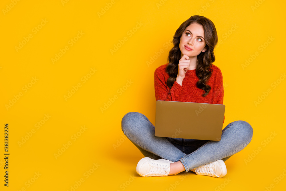 Naklejka premium Portrait of her she nice attractive lovely curious cheery wavy-haired girl sitting using laptop creating it start-up project isolated on bright vivid shine vibrant yellow color background