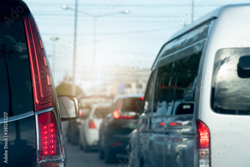 Luxury of black car stop on the asphalt junction by traffic light control in across. Traveling in the provinces during the bright period. Open light brake.