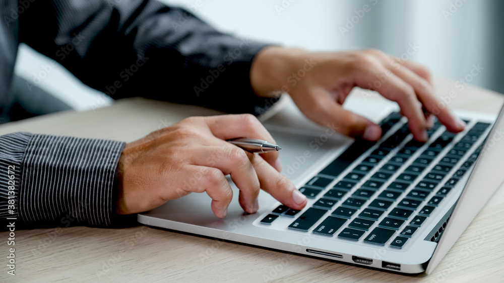 Businessman hands use laptop analysis the busness at the home office for setting challenging business goals And planning to achieve the new target Businessman hands use laptop analysis the busness at the home office for setting challenging business goals And planning to achieve the new target