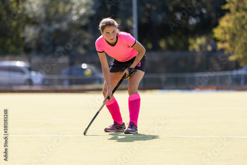 Young female field hockey player on the pitch