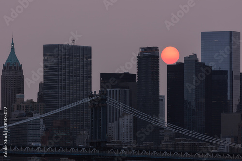 Hazy sunset over the financial district with manhattan bridge