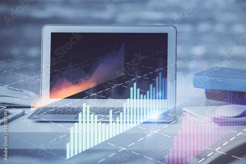 Stock market graph on background with desk and personal computer. Multi exposure. Concept of financial analysis. © peshkova