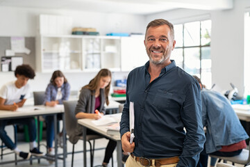 Mature man professor standing in class