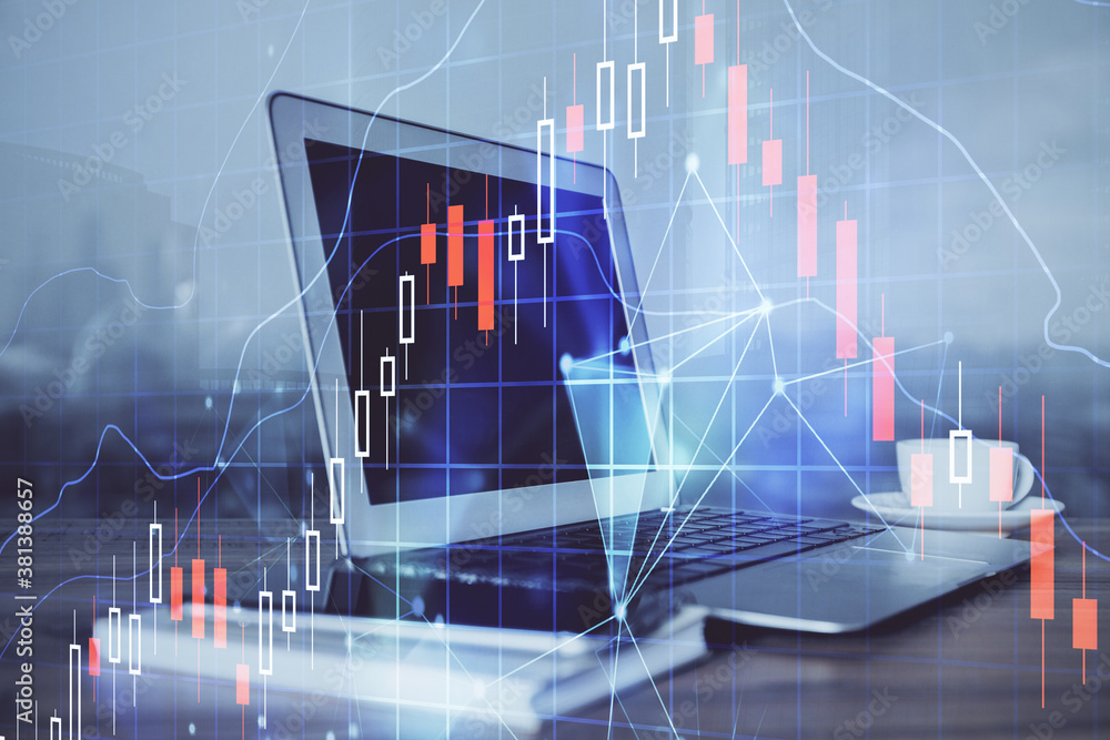 Stock market chart hologram drawn on personal computer background. Multi exposure. Concept of investment. Stock market chart hologram drawn on personal computer background. Multi exposure. Concept of investment.