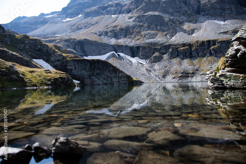 Reflection of the mountain lake "Plattachsee" in sunshine