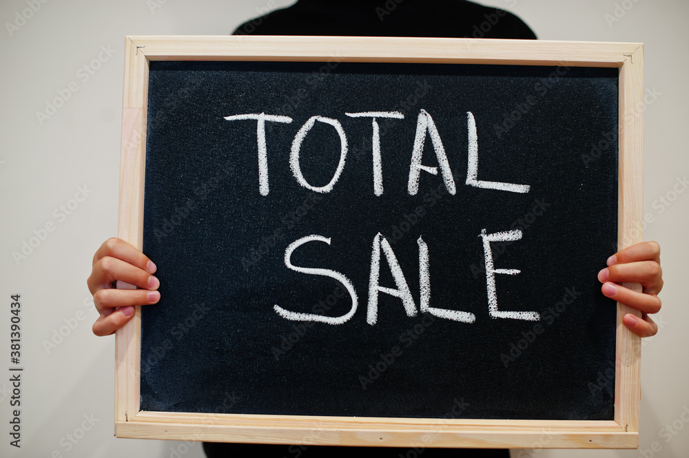 Total sale written on blackboard. Black friday concept. Boy hold board. Total sale written on blackboard. Black friday concept. Boy hold board.