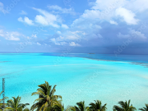 Blue Maldive islands seascape with cloudy sky