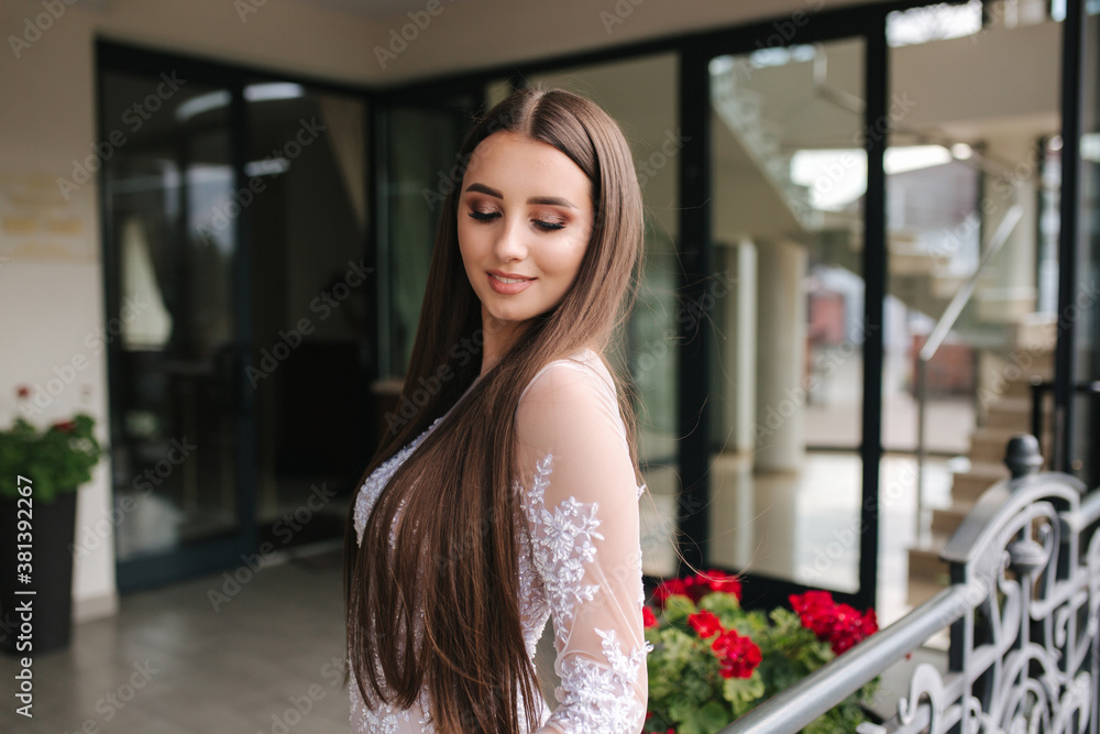 Beautiful young model in evening drees posing to photographer Beautiful young model in evening drees posing to photographer