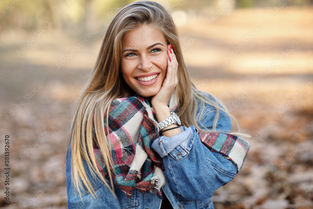 Portrait of a beautiful blonde with a smile on face in the park Portrait of a beautiful blonde with a smile on face in the park