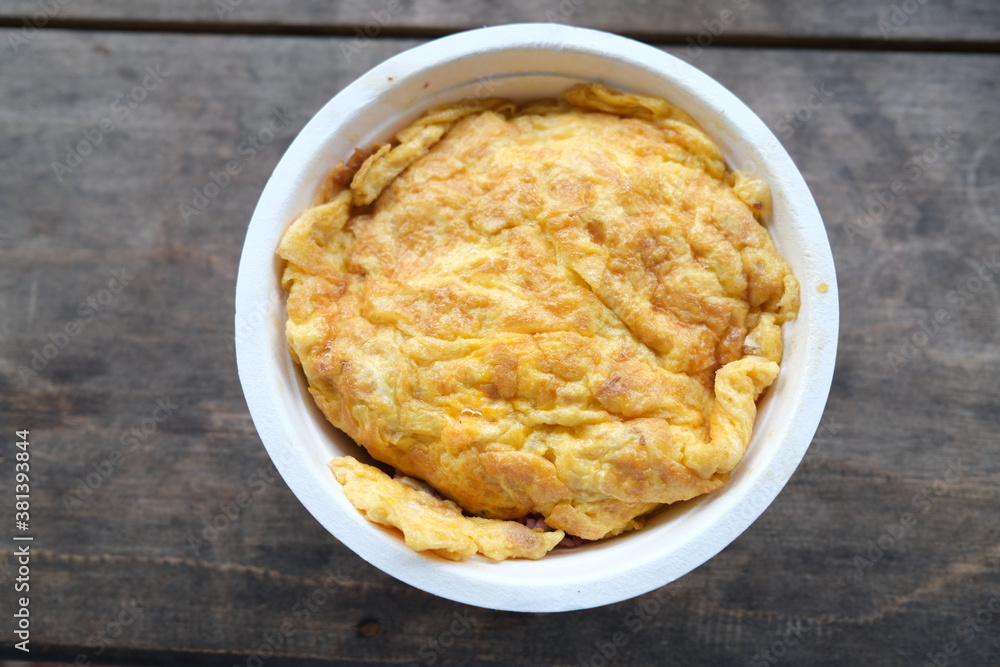 Focus on Thai-style pork omelet served on an organic recycle bowl Focus on Thai-style pork omelet served on an organic recycle bowl