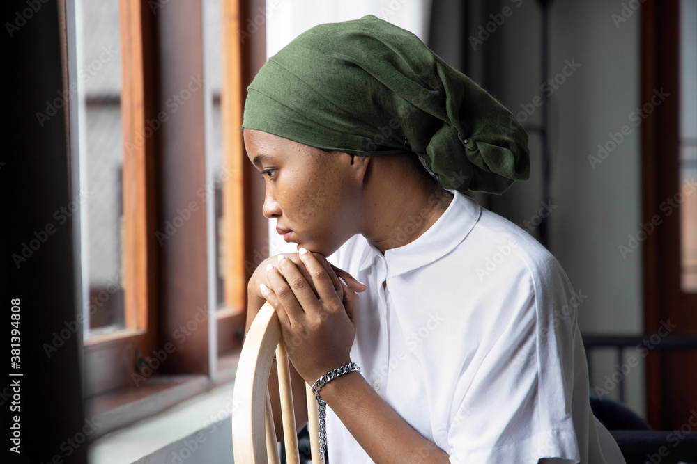 Portrait of sad African young woman cancer patient fighting with the  sickness, wearing head scarf after suffering serious hair loss side effect  due to chemotherapy, concept of cancer awareness Photos | Adobe