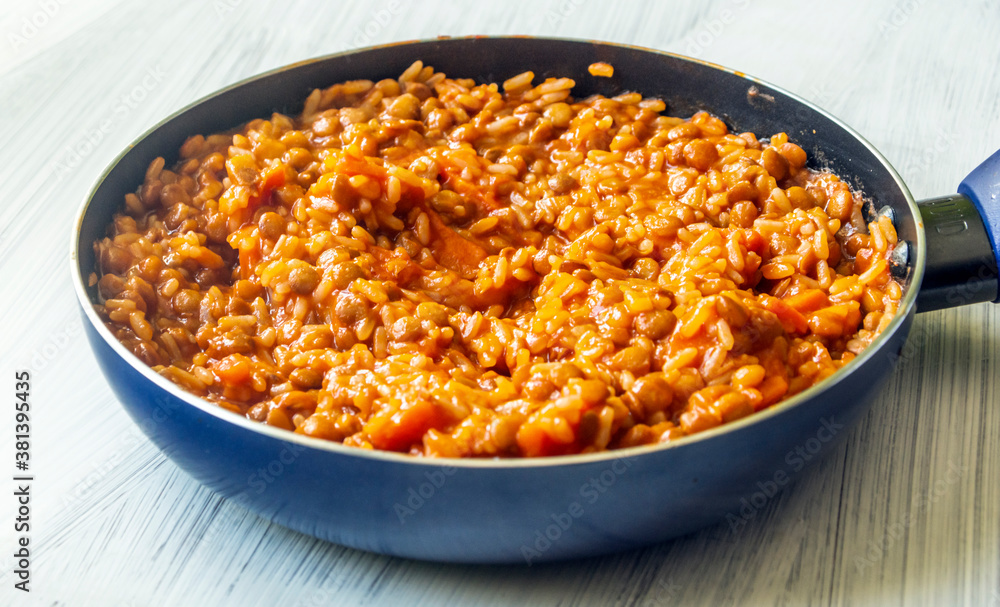 Lentils and rice in a pan surrounded by white background Lentils and rice in a pan surrounded by white background