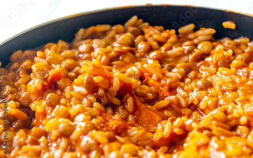 Lentils and rice in a pan surrounded by white background photo