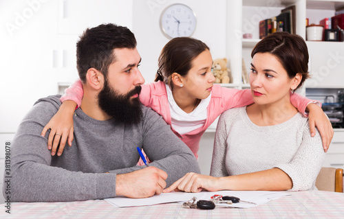 Father and mother preparing divorce papers while their child at home