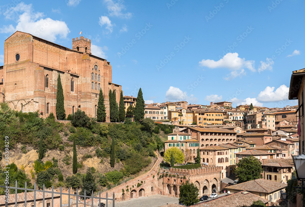 View of the 13th century church Basilica of San Domenico (Basilica Cateriniana) and surrounding houses in Siena, Tuscany, Italy