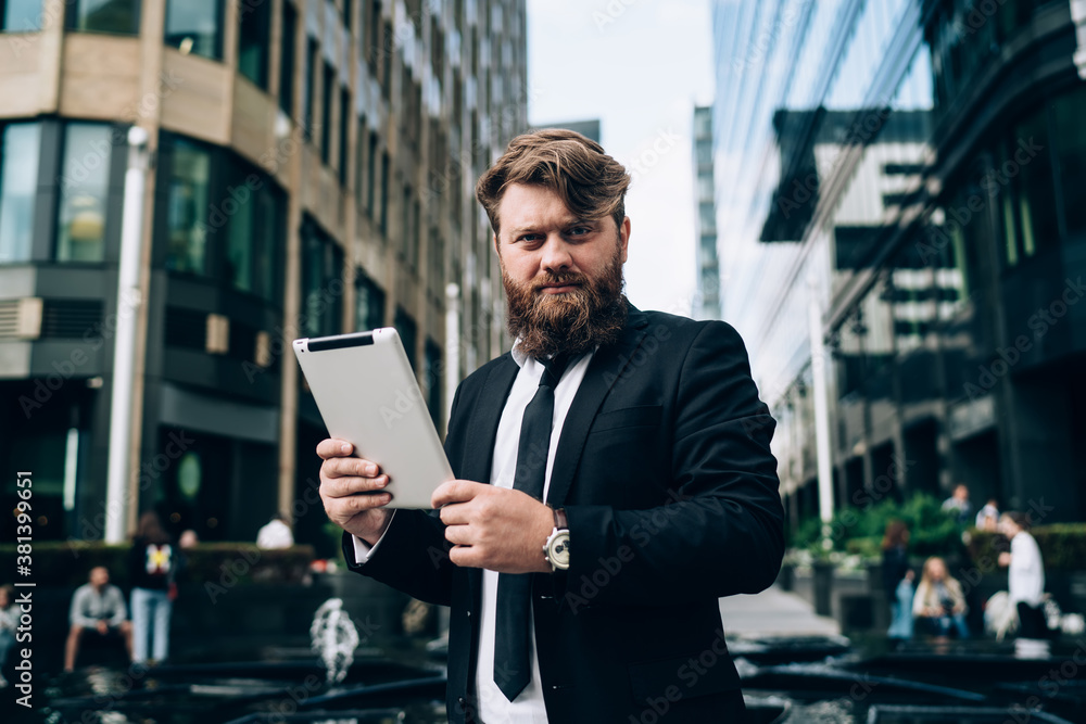 Confident bearded businessman with tablet Confident bearded businessman with tablet