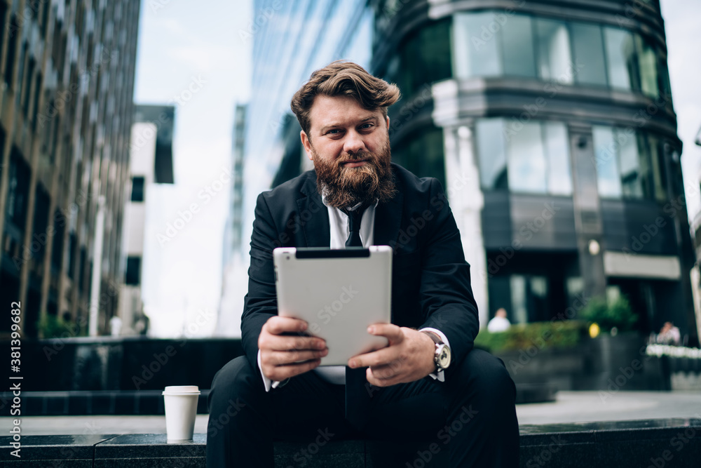 Thoughtful businessman with tablet in hands Thoughtful businessman with tablet in hands