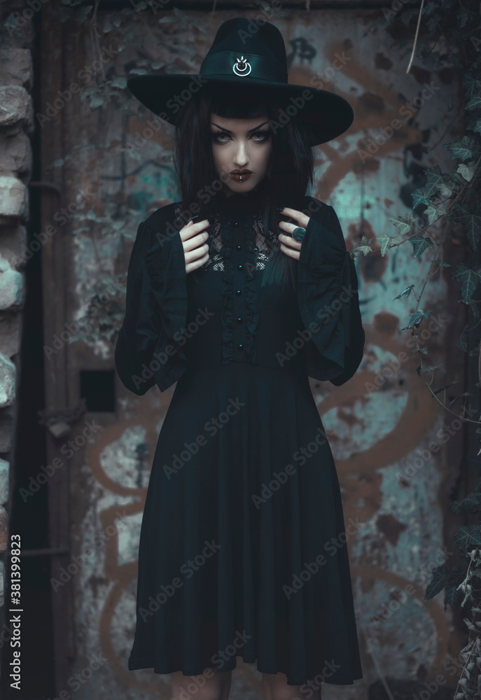 Young beautiful gothic enchantress in the forest