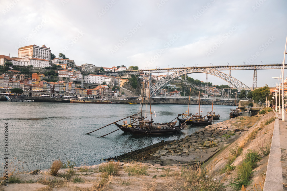 charming landscape of the river with a bridge and small ships parked on the river bank.  landscape of Porto city