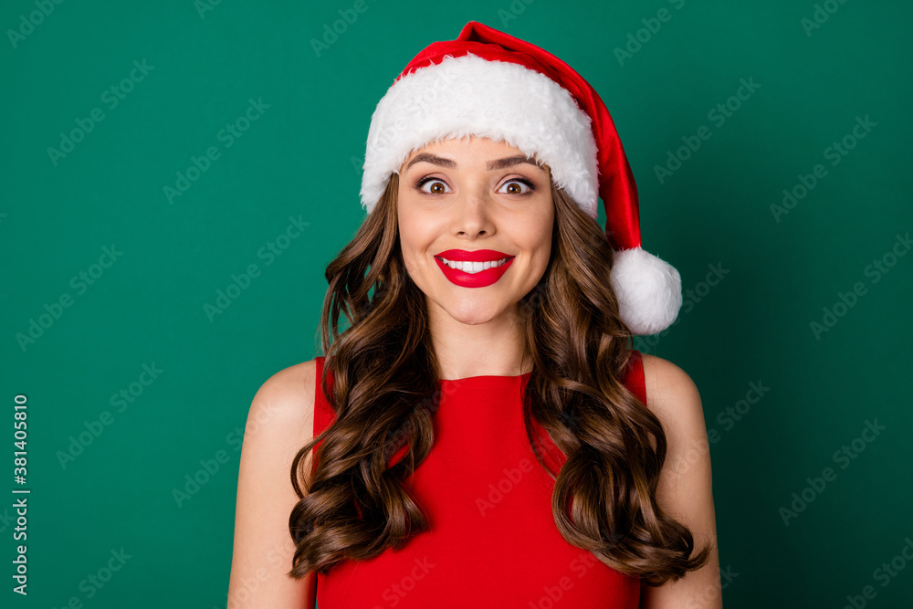 Photo of positive charming nice girl in santa claus red headwear enjoy x-mas holly jolly newyear event wear good look skirt isolated over green color background Photo of positive charming nice girl in santa claus red headwear enjoy x-mas holly jolly newyear event wear good look skirt isolated over green color background