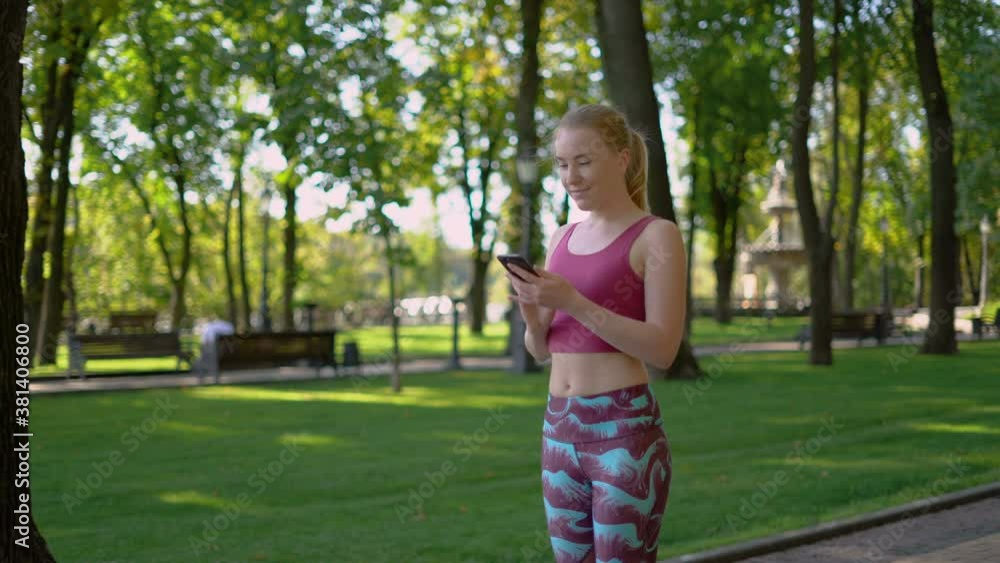 30 years old young girl athlete looks at the application on the phone. 4K 30 years old young girl athlete looks at the application on the phone. 4K