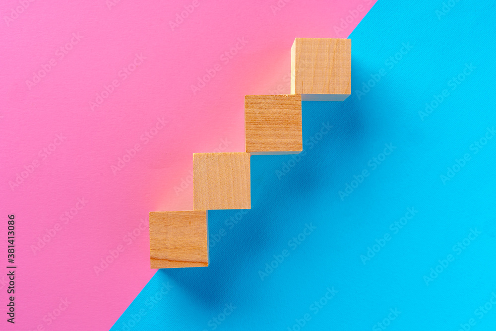 Top view photo of wooden blocks on pink and blue Top view photo of wooden blocks on pink and blue