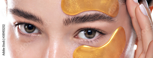 Close up eyes of a young woman with cosmetic patches.