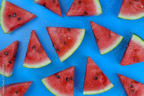 Slices of ripe watermelon on a blue background, texture, patern