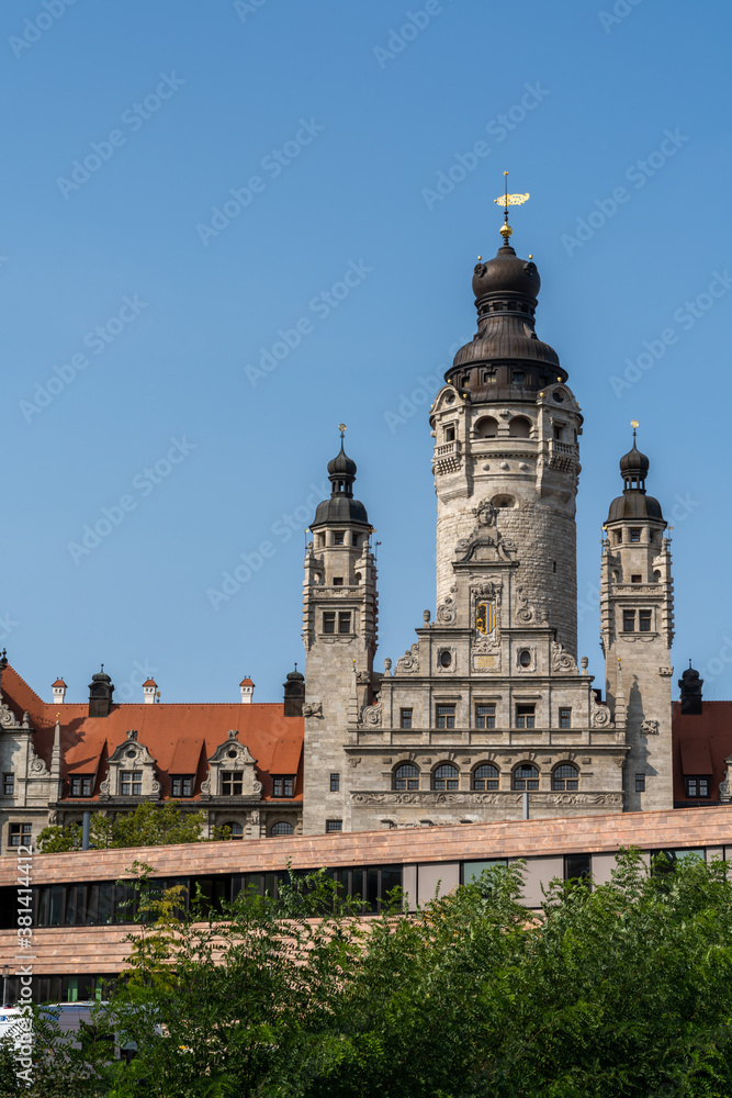 the old city hall building in Leipzig with the church of St. Trinitatis in the foreground