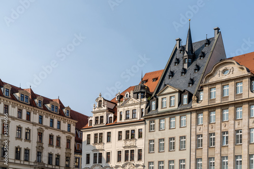 historic buildings in the city center of Leipzig under a ble sky