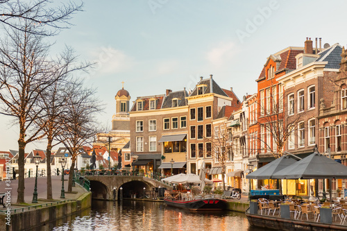 Afternoon view of the Nieuwe Rijn canal with bridge and historic buildings in the city center of Leiden