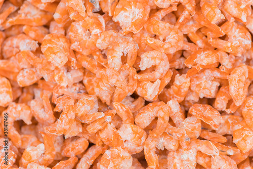 Dry shrimps of various sizes in the basket for sale in supermarket for customer.
