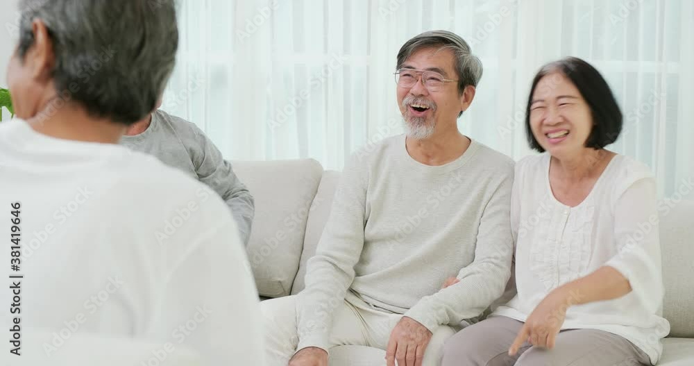 Happy emotion concept. Senior people laughing together at living room. Senior man talking funny story to his friend at home. Retirement activity or lifestyle concept. Happy emotion concept. Senior people laughing together at living room. Senior man talking funny story to his friend at home. Retirement activity or lifestyle concept.