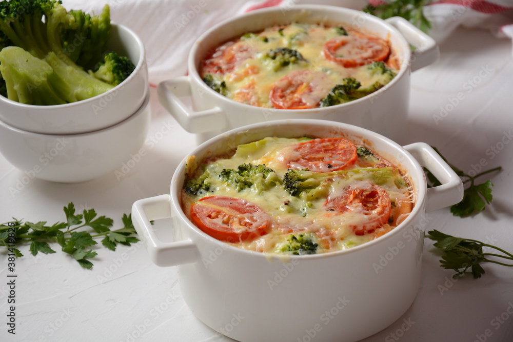Broccoli, cheese and egg casserole in baking cocottes Broccoli, cheese and egg casserole in baking cocottes