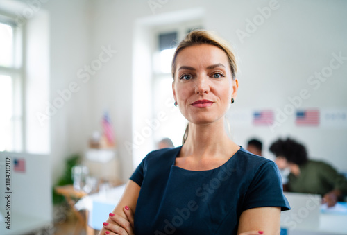 Portrait of confident woman voter in polling place, usa elections concept.