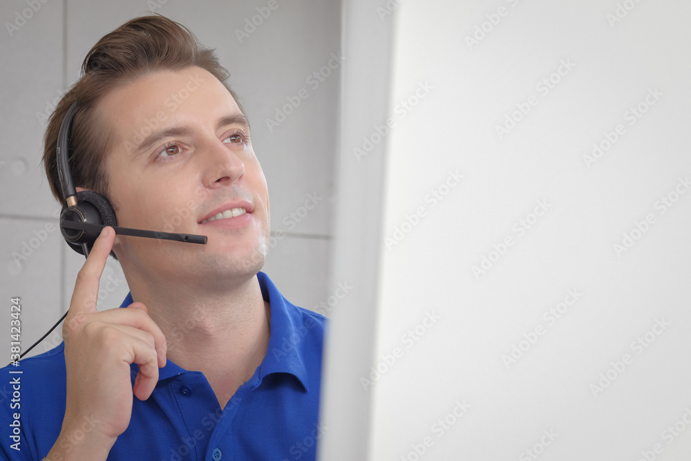 Smart and handsome caucasian male operator speaking on the headset with confident gesture for customer solution, copy space computer screen. Smart and handsome caucasian male operator speaking on the headset with confident gesture for customer solution, copy space computer screen.