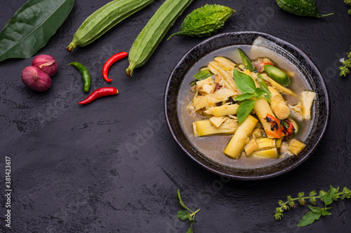 Bilde på lerret Local food in rural Thailand, bamboo shoot curry in black bowl placed on black background