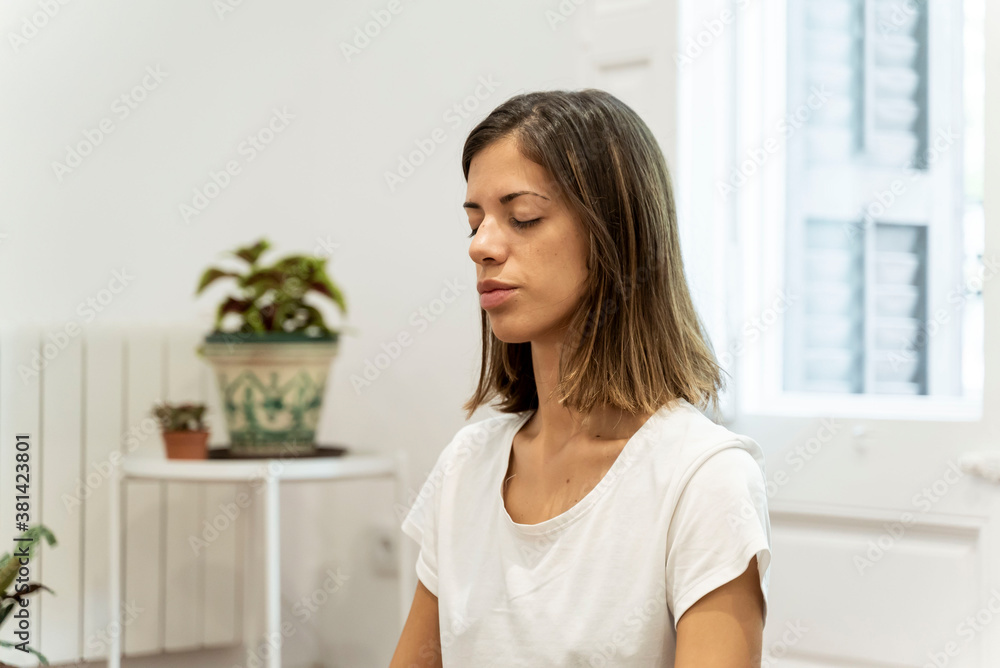 Young girl doing yoga in her living room. Young girl doing yoga in her living room.