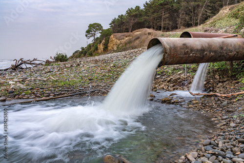 Dirty sewage from a factory pipe, chemical pollution of environment