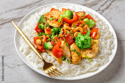 Asian cashew chicken on a white marble background