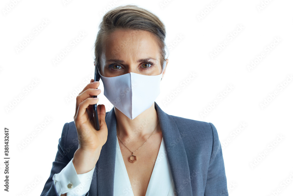 elegant business woman in grey suit talking on phone on white