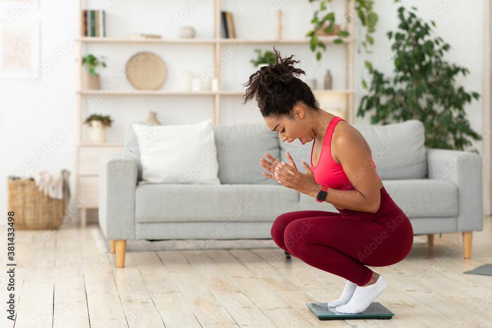 Black Lady Shouting Standing On Weight-Scales After Weight Gain Indoor Black Lady Shouting Standing On Weight-Scales After Weight Gain Indoor