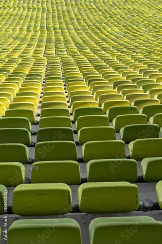 endless rows of enpty chairs in a stadium