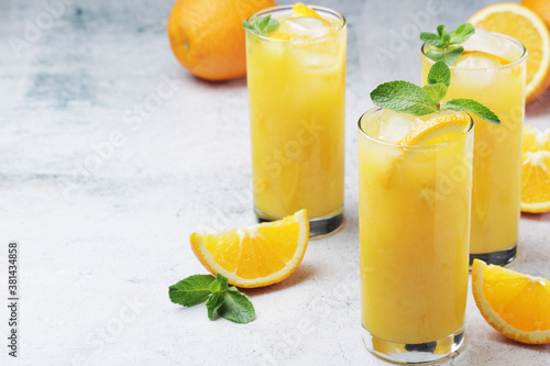 Glasses full of orange juice with ice