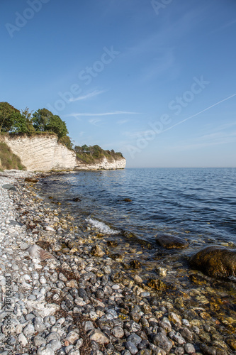 Fototapeta Naklejka Na Ścianę i Meble -  Stevns Klint is a steep coast in the southeast of the Danish Baltic Sea island of Zealand. The cliff is about 15 kilometers long and rises up to 41 meters above sea level. In 2014 UNESCO awarded the c