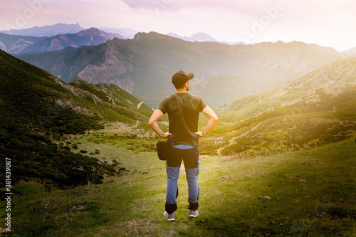 Man with cap on top of the mountain