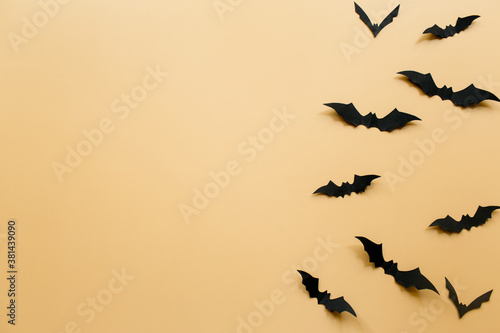 Halloween decorations with bats on pastel beige background. Halloween concept. Flat lay, top view, copy space © Tatiana