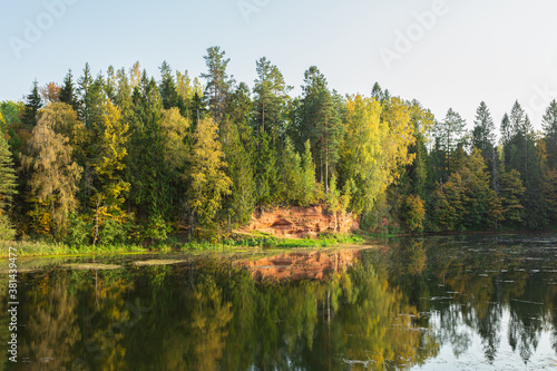 Picturesque lake and a sand quarry in the autumn forest in Rozhdestveno, Saint Petersburg, Russia. Horizontal image.