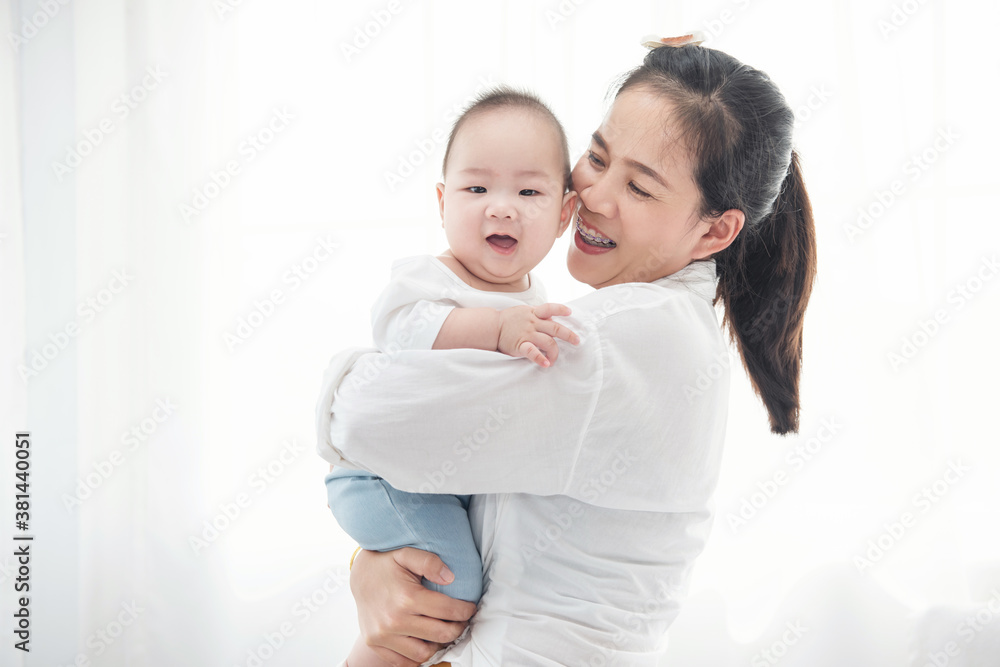 Happy asian mother playing with newborn baby. Closeup portrait of beautiful young mom and her son infant. Healthcare and medical family love lifestyle asia mother’s day concept Happy asian mother playing with newborn baby. Closeup portrait of beautiful young mom and her son infant. Healthcare and medical family love lifestyle asia mother’s day concept