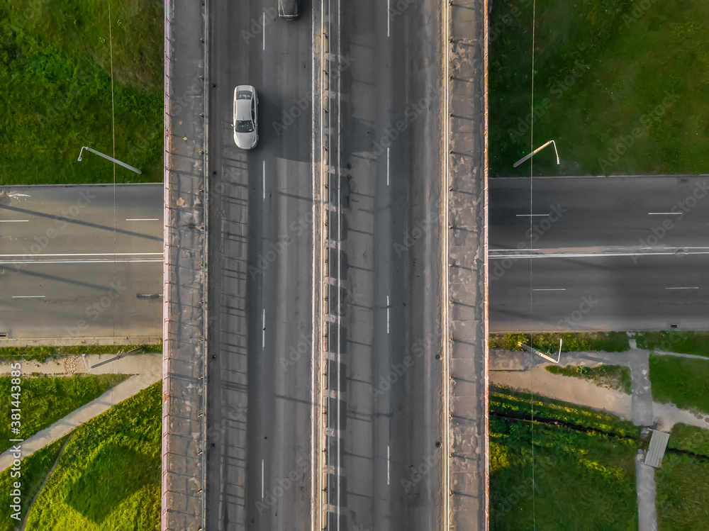 Obraz premium Bridge with cars over the road, drone view from top to bottom. City infrastructure.